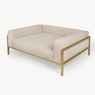 Looty Kensington dog sofa, medium, in beige fabric on a gold-tone steel frame, three-quarter view. photograph: Looty