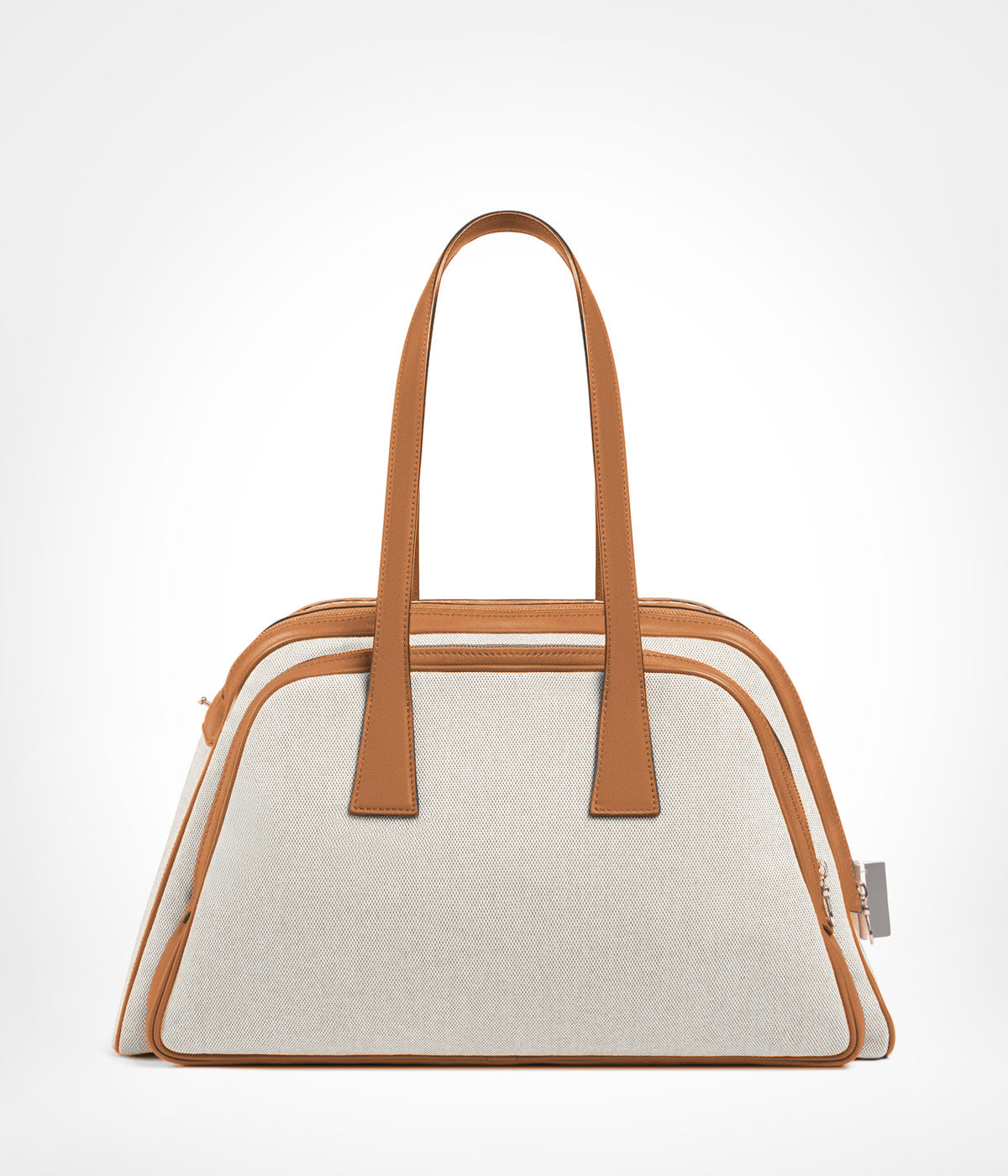 Aviteur leather-trim canvas pet carrier in beige canvas with tan calf leather trim, front view showing the two top handles. photograph: Aviteur