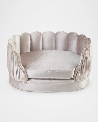 Haute House Lily Rose velvet pet bed in blush velvet on a scalloped frame, channel-tufted inside with nailhead trim. photograph: Haute House for Neiman Marcus