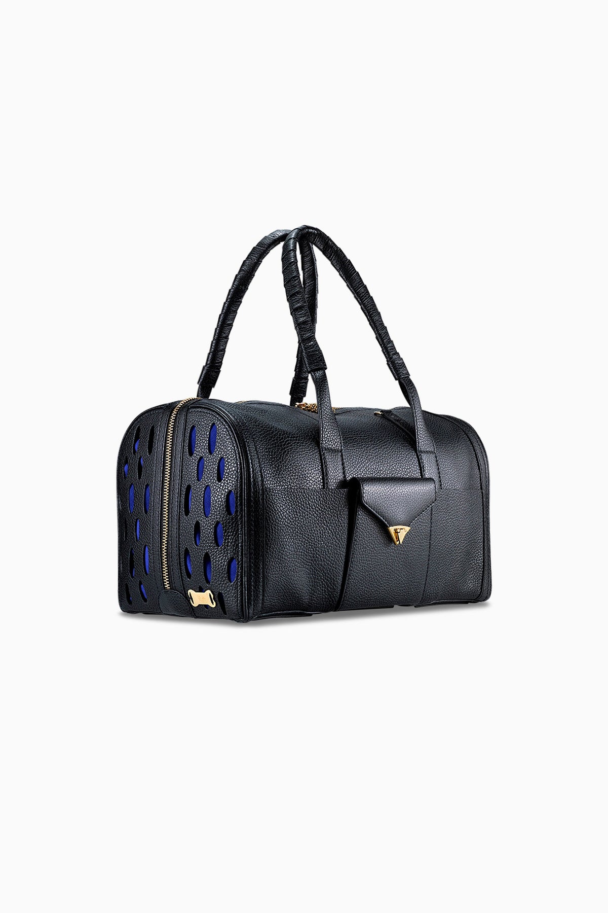 Tyler Ellis Josh pet carrier in black pebbled leather, three-quarter view showing the perforated panel and dog-bone plaque. photograph: Tyler Ellis