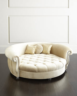 Haute House Harlow cuddle pet bed in cream upholstery on a hardwood frame, with jeweled nailhead trim and three pillows. photograph: Haute House for Neiman Marcus